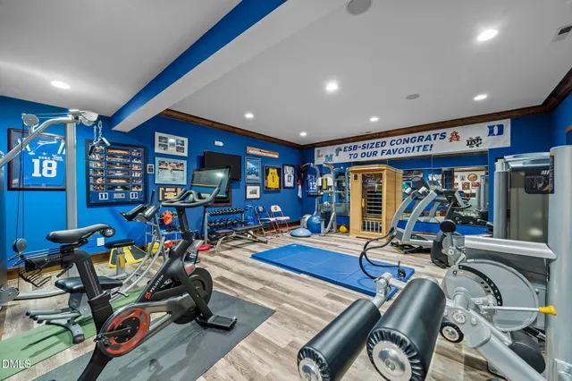 an aerial view of a house with a yard and trees all around