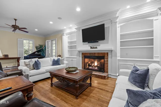 a living room with furniture a window and a flat screen tv