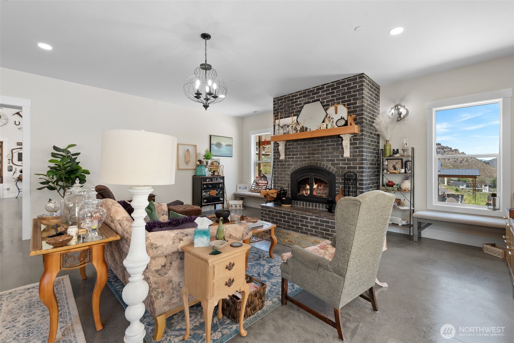 1541 Pitcher Canyon Road Wenatchee, WA 98801 - Photo 12 of 40 a living room with furniture a fireplace and a chandelier