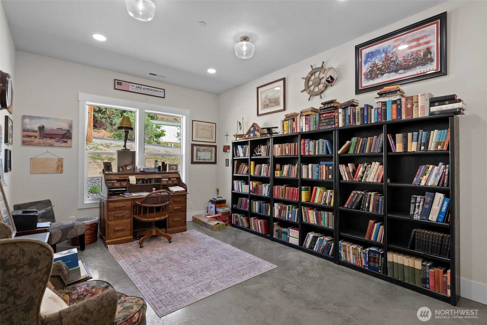 1541 Pitcher Canyon Road Wenatchee, WA 98801 - Photo 30 of 40 a living room with furniture a rug and a book shelf
