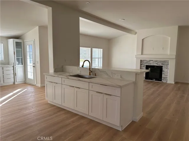 a kitchen with a sink and a stove top oven