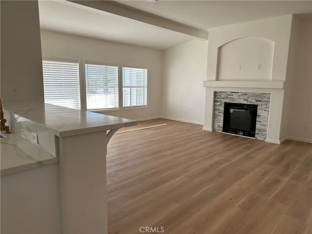 a spacious bathroom with a vanity a mirror a bathtub and a window