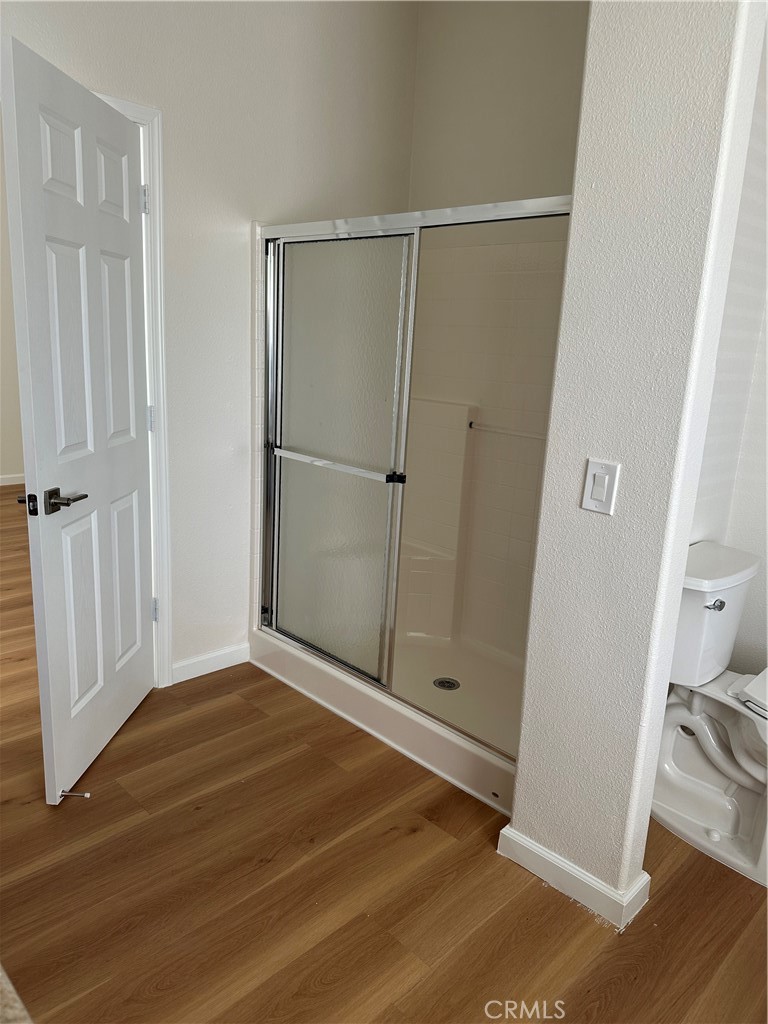 21204 Versaie Perris, CA 92570 - Photo 20 of 33 a view of an empty room with wooden floor and a window