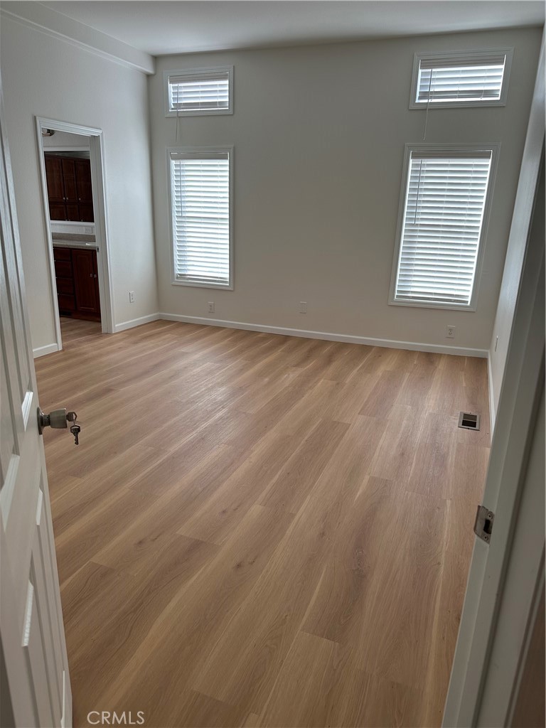 21204 Versaie Perris, CA 92570 - Photo 25 of 33 a view of an empty room with wooden floor and a window