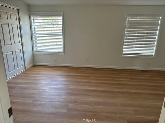 a view of kitchen with stainless steel appliances granite countertop a stove top oven a sink dishwasher and a refrigerator with wooden floor