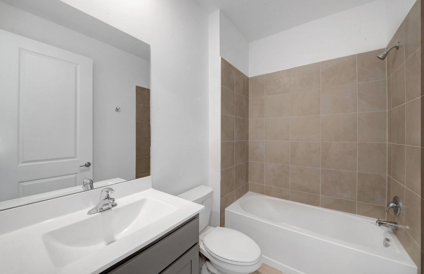 14511 Three Ponds Trail Delray Beach, FL 33446 - Photo 12 of 33 a bathroom with a bathtub shower sink vanity mirror and toilet