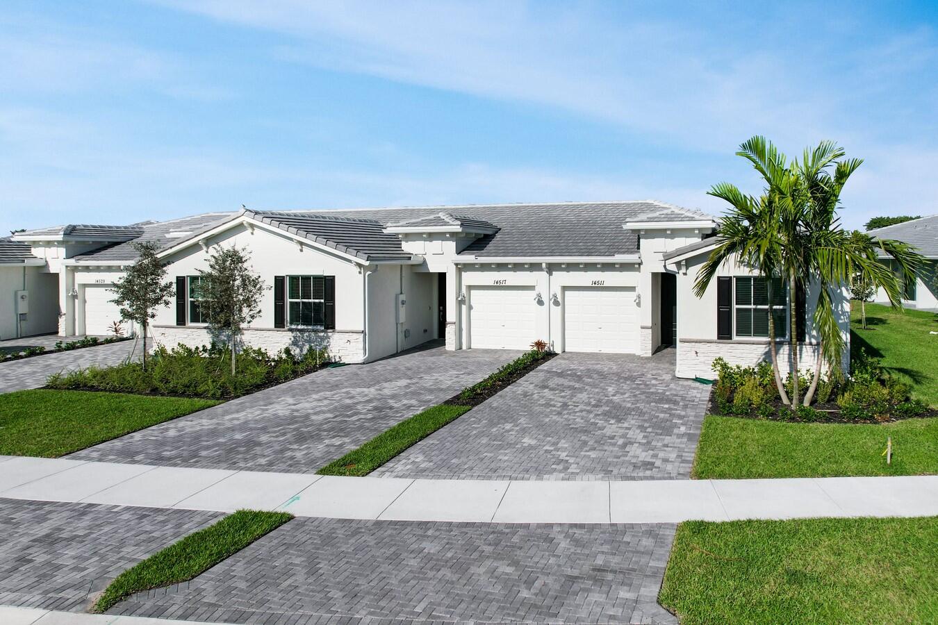 14511 Three Ponds Trail Delray Beach, FL 33446 - Photo 16 of 33 a front view of a house with a yard and garage