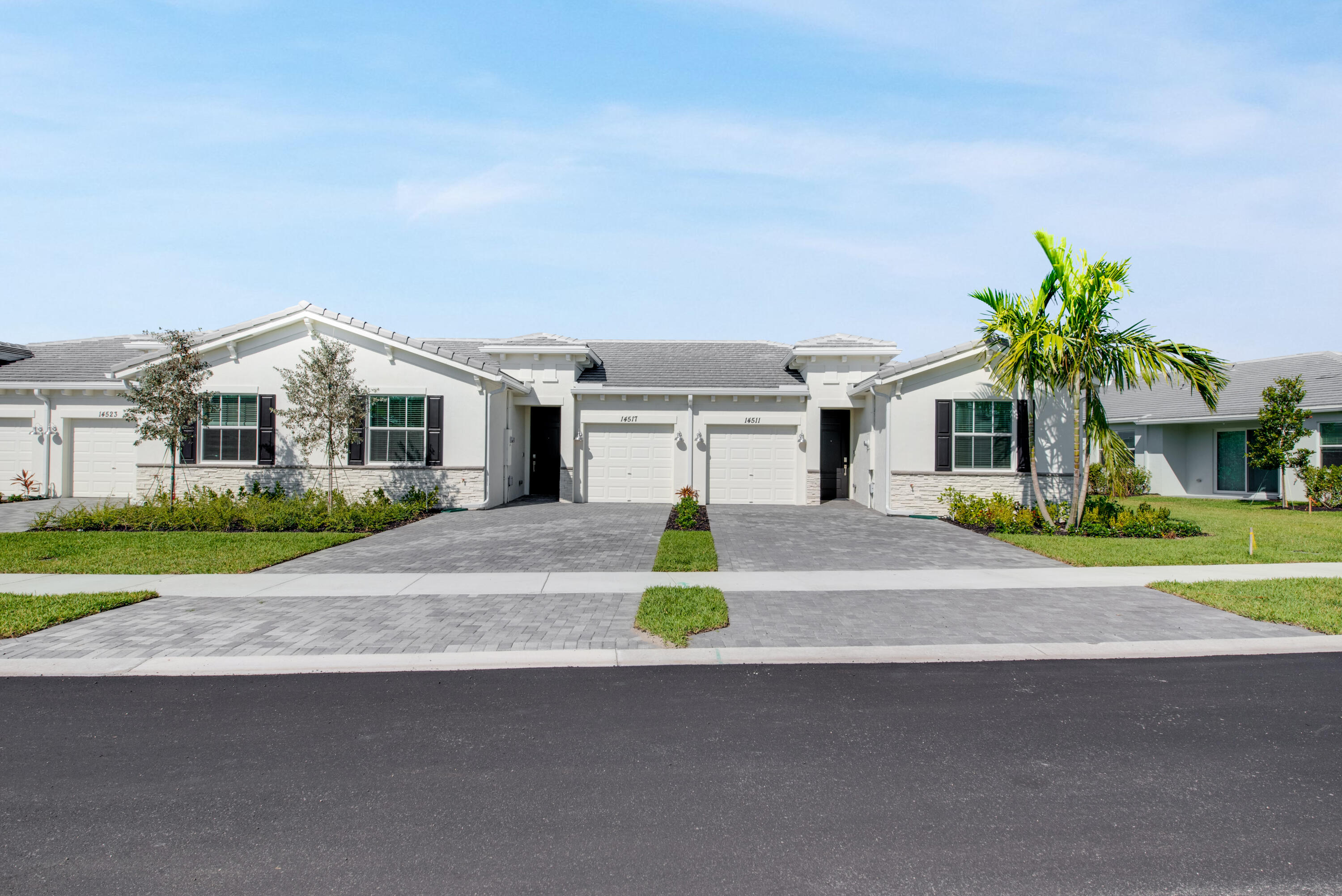 14511 Three Ponds Trail Delray Beach, FL 33446 - Photo 18 of 33 a front view of a house with a garden and parking
