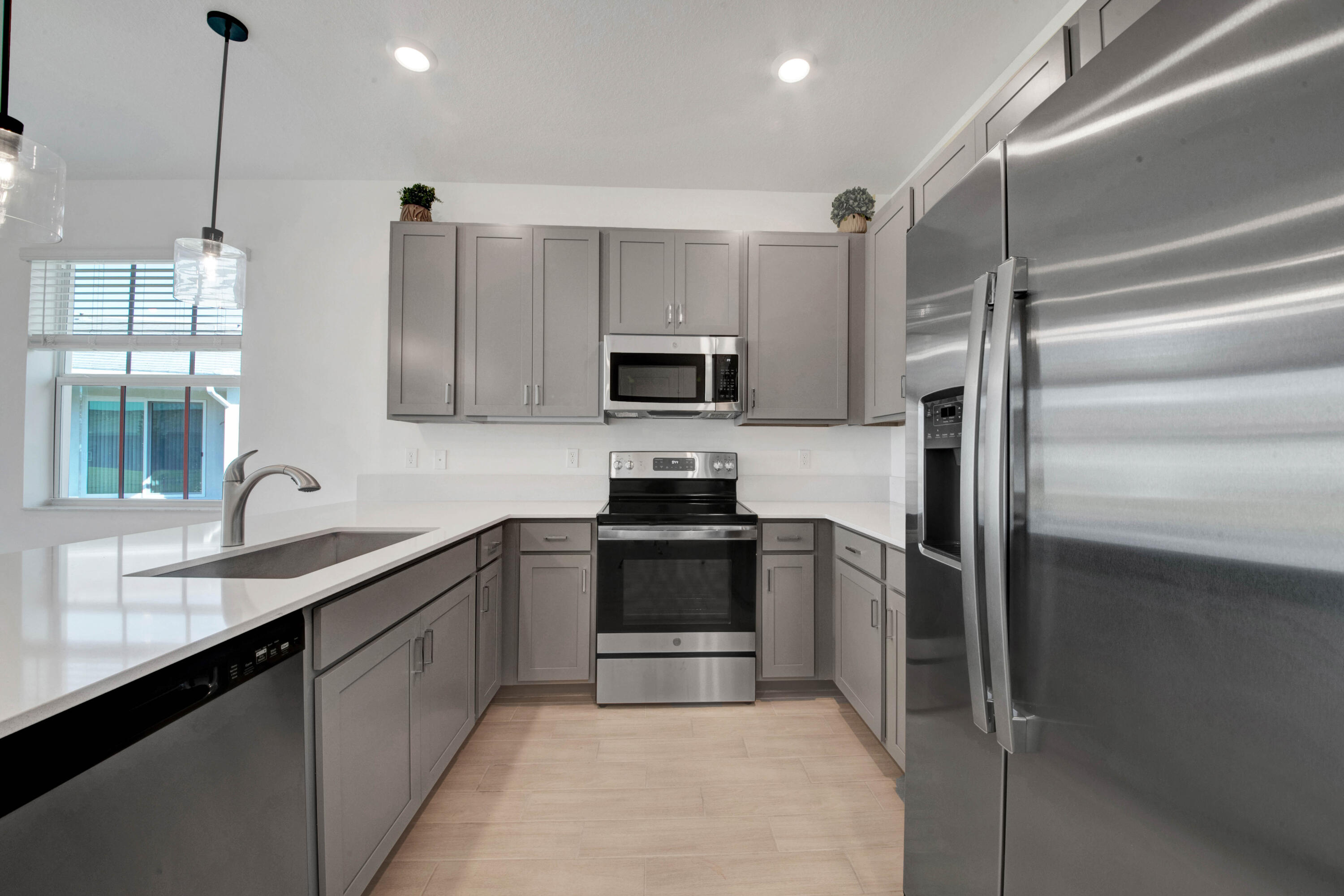 14511 Three Ponds Trail Delray Beach, FL 33446 - Photo 3 of 33 a kitchen with a sink stainless steel appliances and cabinets