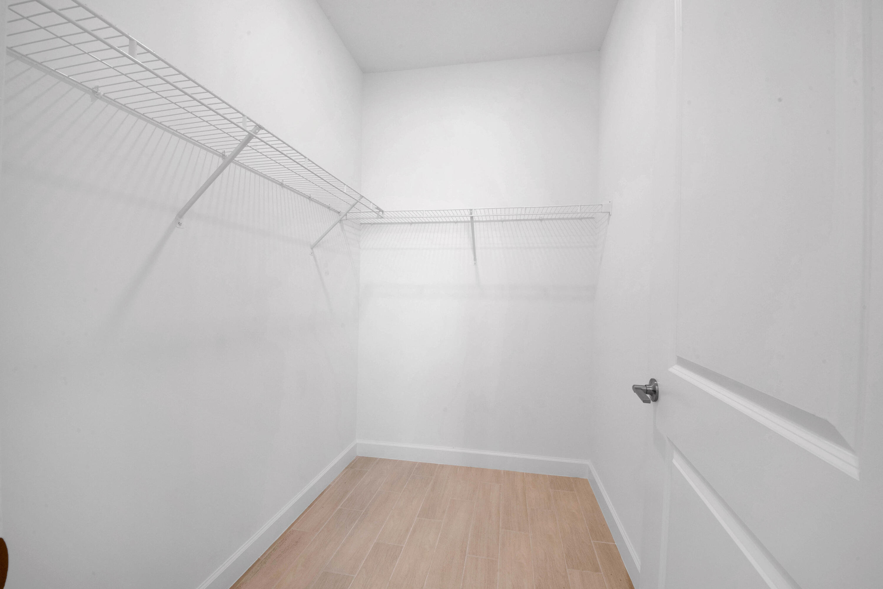 14511 Three Ponds Trail Delray Beach, FL 33446 - Photo 8 of 33 a view of a room with racks on the wall