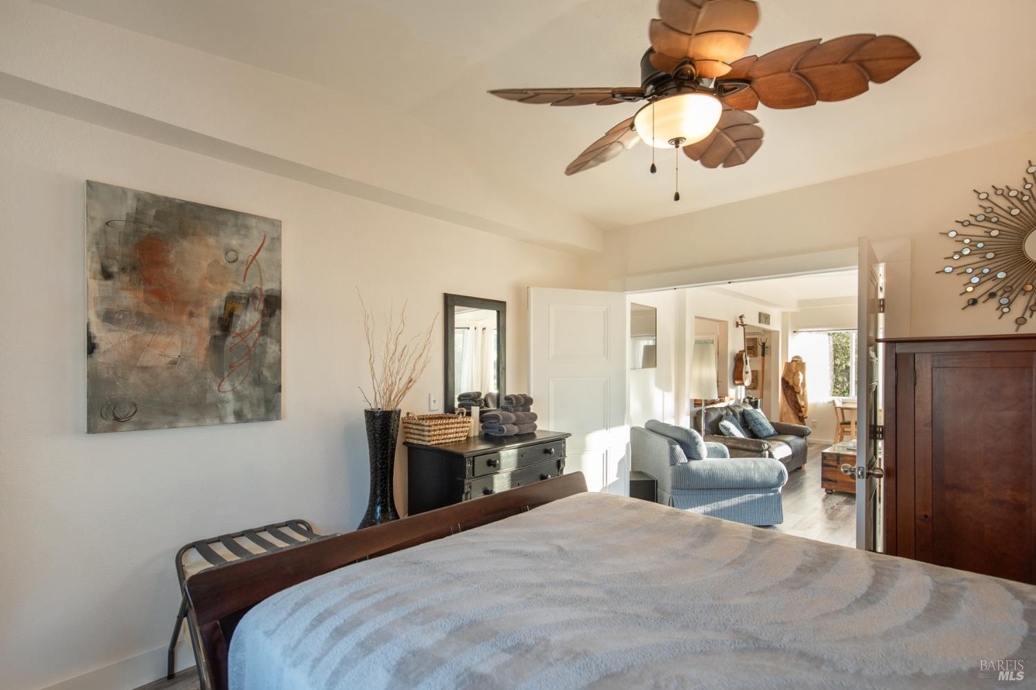 22855 Chianti Road Cloverdale, CA 95425 - Photo 40 of 76 a bedroom with a bed a large mirror and furniture