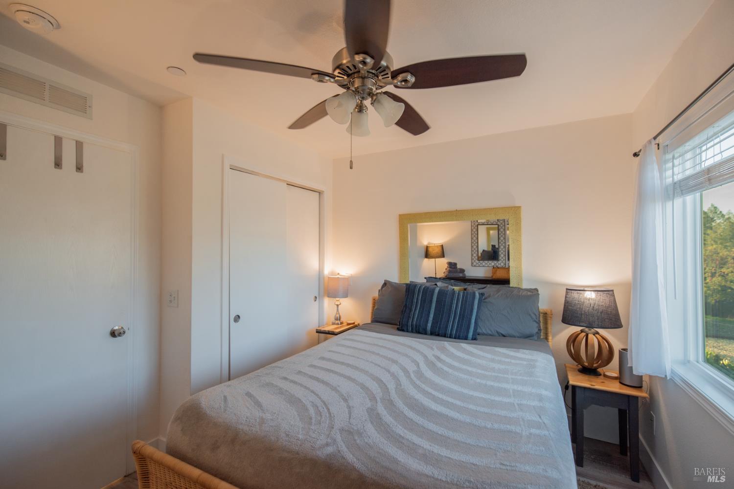 22855 Chianti Road Cloverdale, CA 95425 - Photo 46 of 76 a bedroom with a bed and wooden floor
