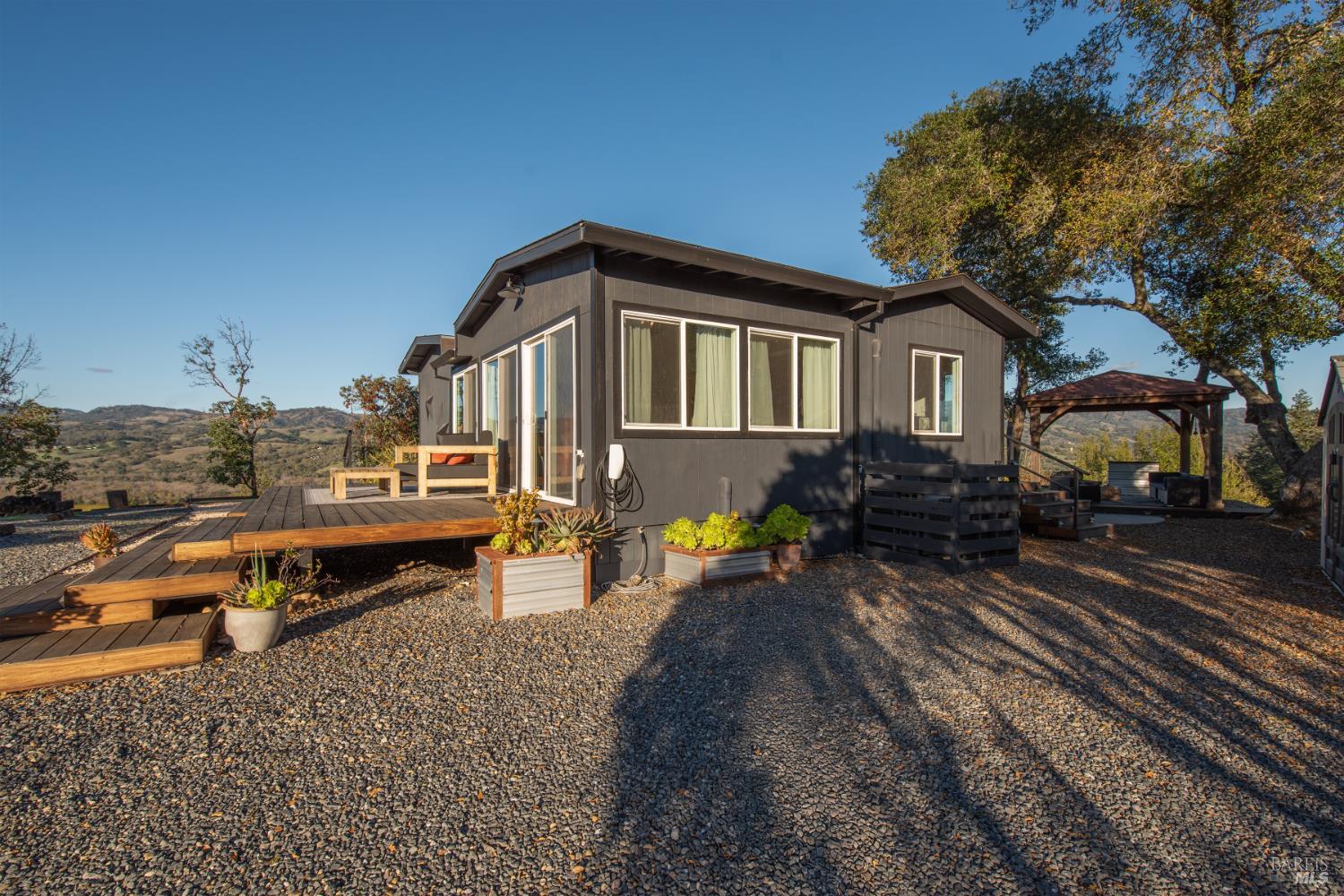 22855 Chianti Road Cloverdale, CA 95425 - Photo 61 of 76 a view of a house with a yard and sitting area