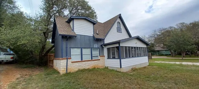 a house with trees in the background