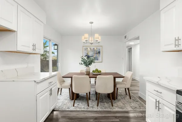 a view of a dining room with furniture and chandelier