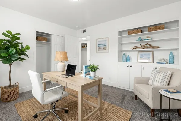 a workspace with furniture and a potted plant
