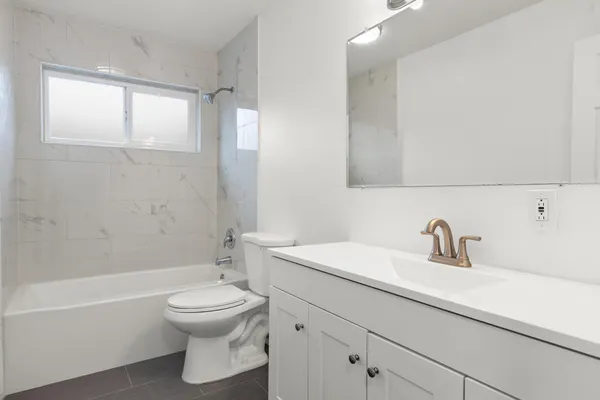 a bathroom with a sink a toilet and a bathtub