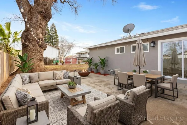 a view of a patio with couches and a fire pit and a fire pit