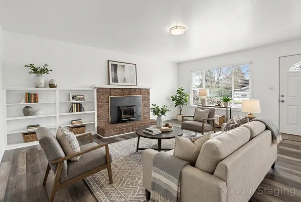 a living room with furniture fireplace and a window