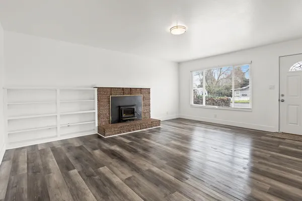 wooden floor fireplace and natural light in room