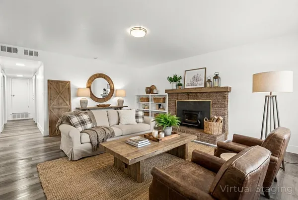 a living room with furniture a clock and a fireplace