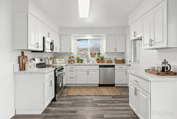a kitchen with a sink white cabinets and white appliances