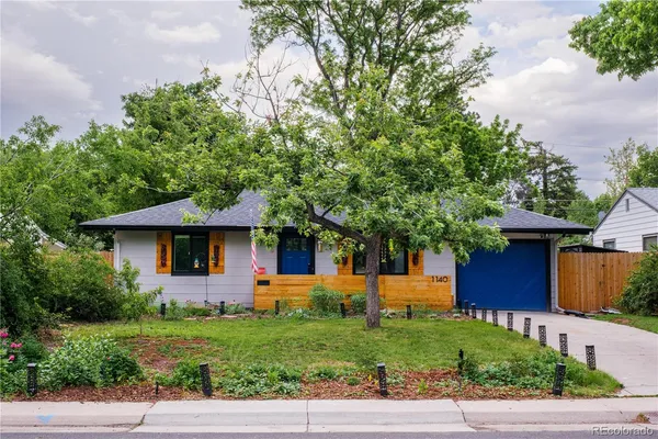 a front view of a house with a yard and a garage