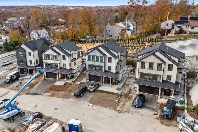 an aerial view of a house with a garden and sitting area