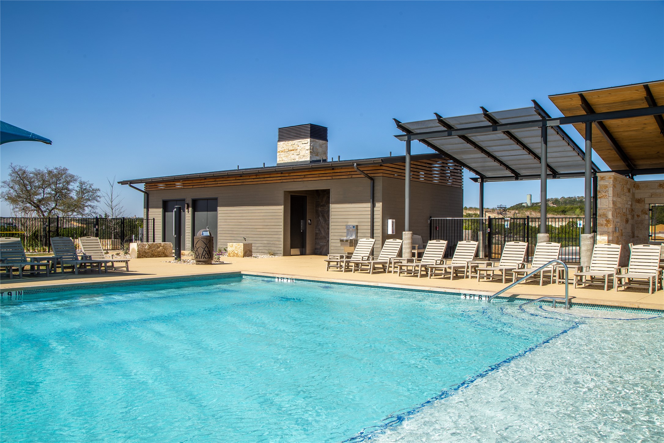 18849 Hidden Ridge Place Jonestown, TX 78645 - Photo 6 of 14 a view of a house with swimming pool and sitting area