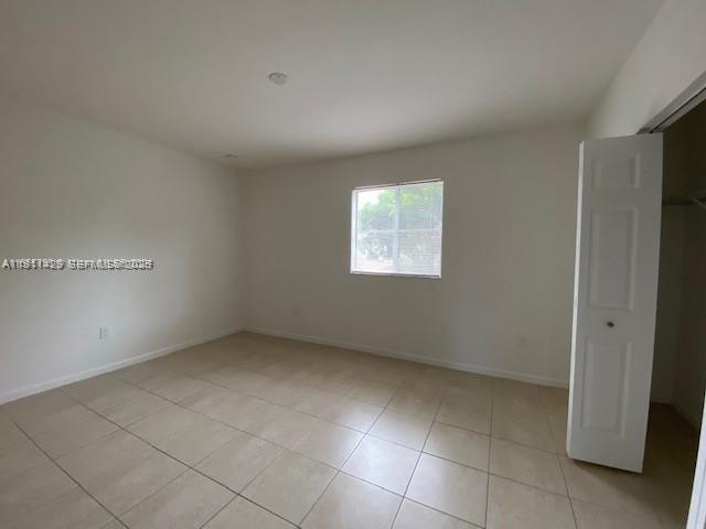 2708 Southwest 83rd Avenue, Unit 105 Miramar, FL 33025 - Photo 5 of 15 an empty room with windows