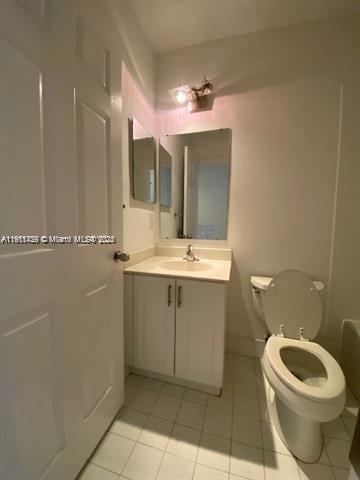 2708 Southwest 83rd Avenue, Unit 105 Miramar, FL 33025 - Photo 10 of 15 a bathroom with a toilet sink and mirror