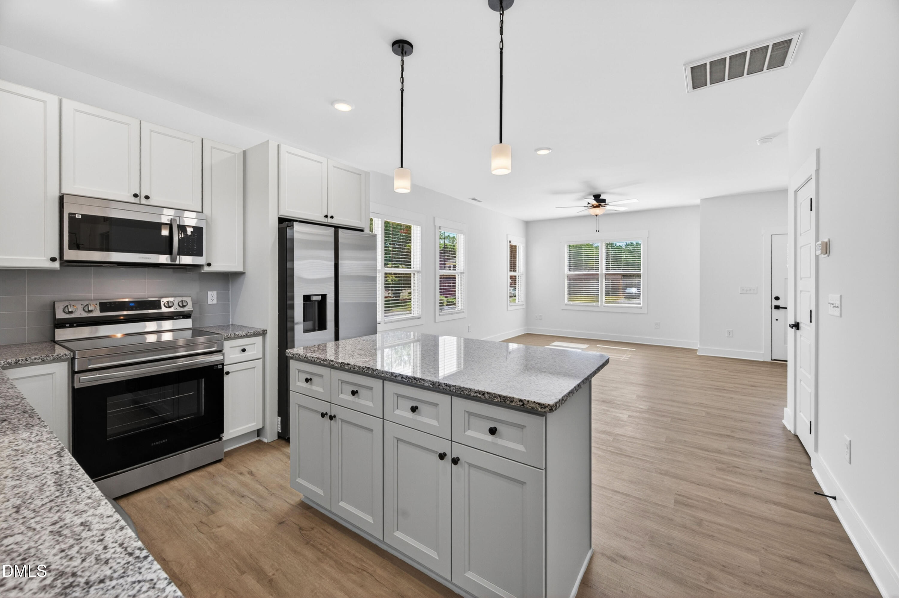 1196 Hurdle Mills Road Roxboro, NC 27573 - Photo 20 of 50 a kitchen with stainless steel appliances granite countertop a stove a sink and a refrigerator