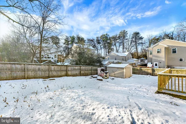 a view of a white house with a yard covered in snow