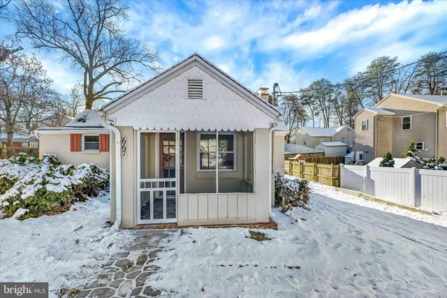 a view of a house with a yard and potted plants