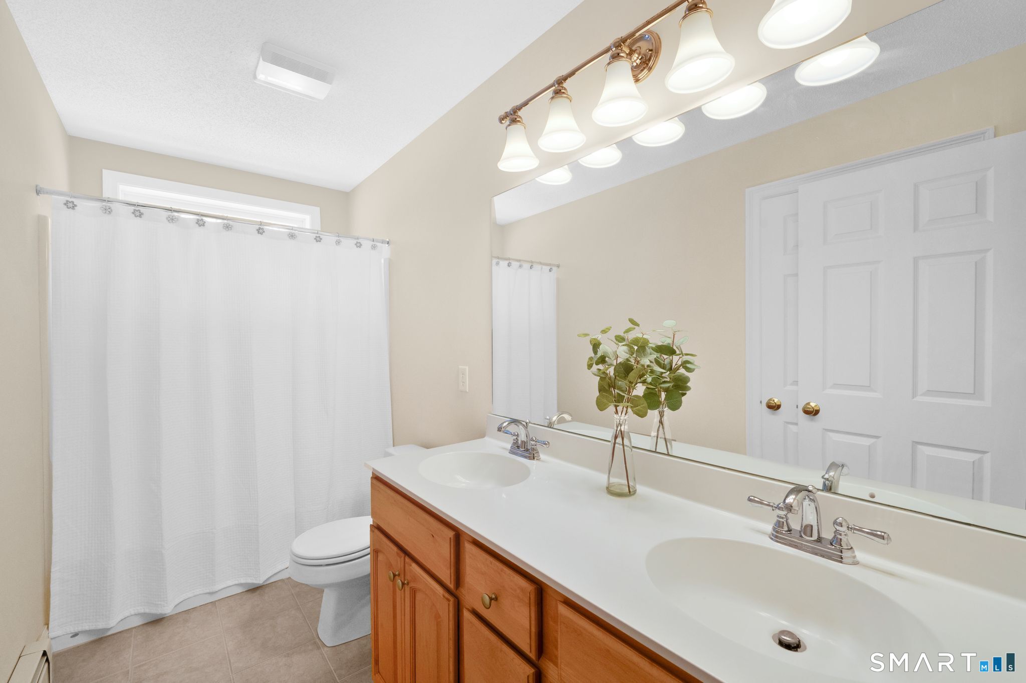 23 Neville Street Coventry, CT 06238 - Photo 29 of 40 a bathroom with a sink a toilet and a mirror