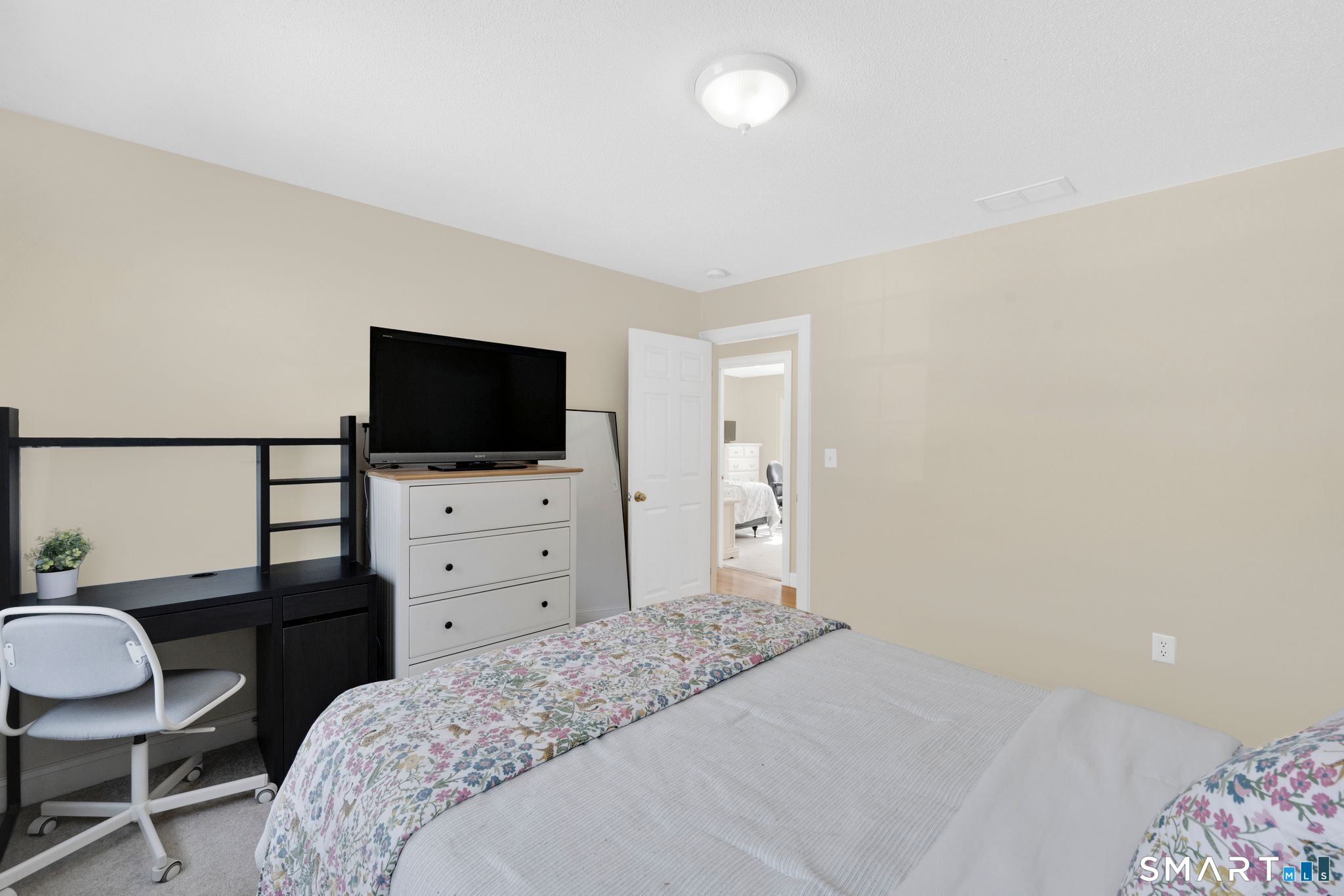 23 Neville Street Coventry, CT 06238 - Photo 30 of 40 a bedroom with a bed and a flat screen tv