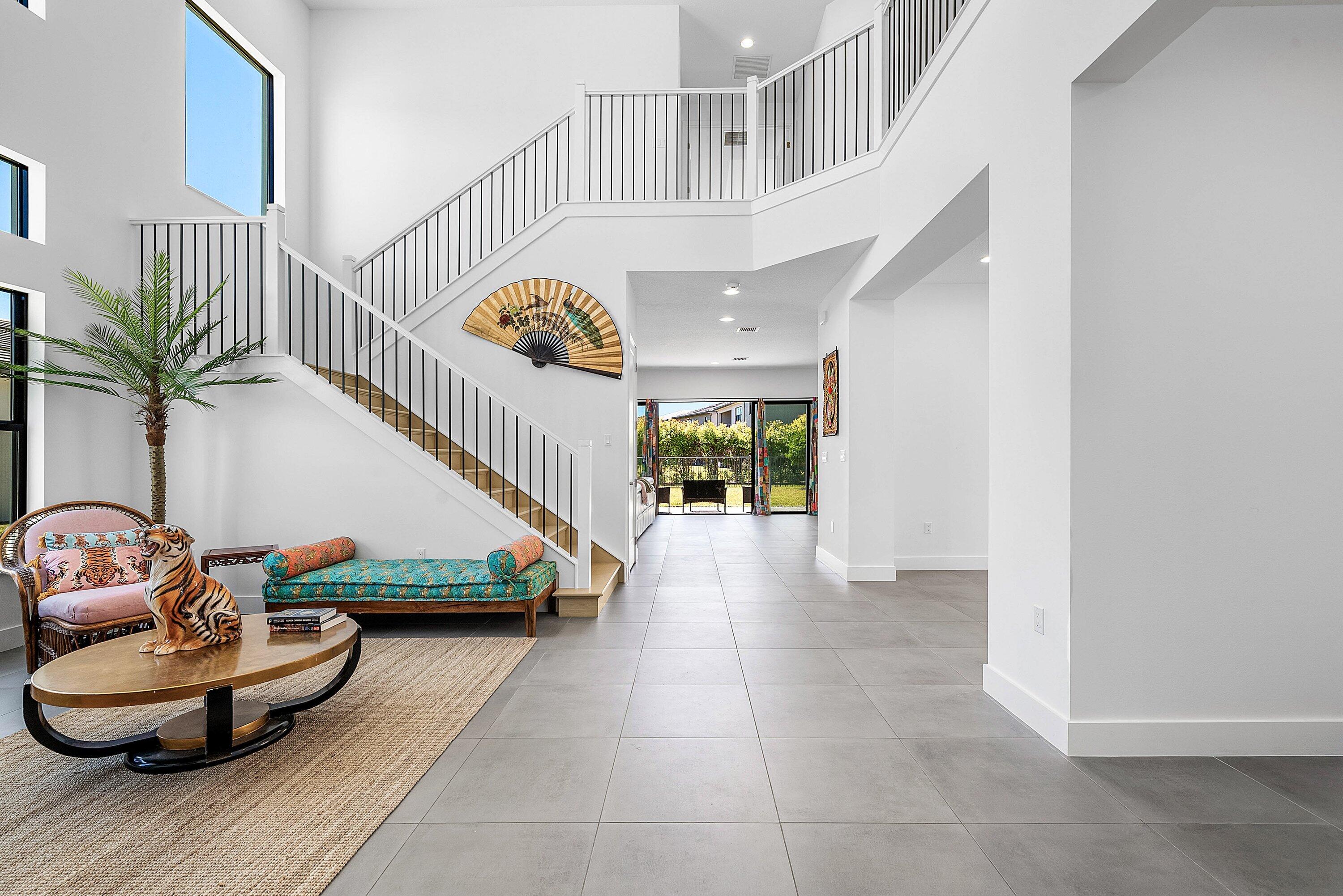 8260 Royal County Down Road Boca Raton, FL 33434 - Photo 11 of 115 a living room with furniture and a potted plant