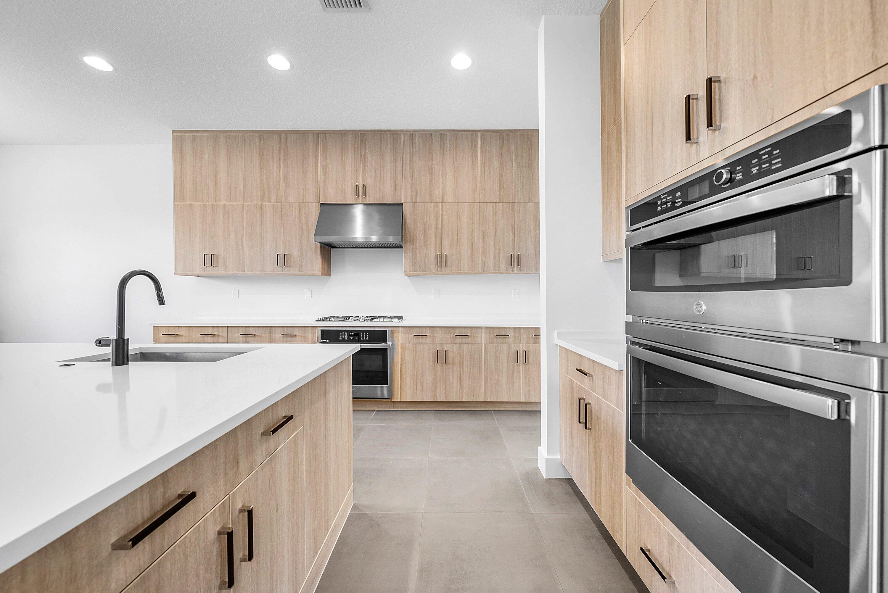 8260 Royal County Down Road Boca Raton, FL 33434 - Photo 19 of 115 a kitchen with stainless steel appliances granite countertop a stove and a sink with granite countertops