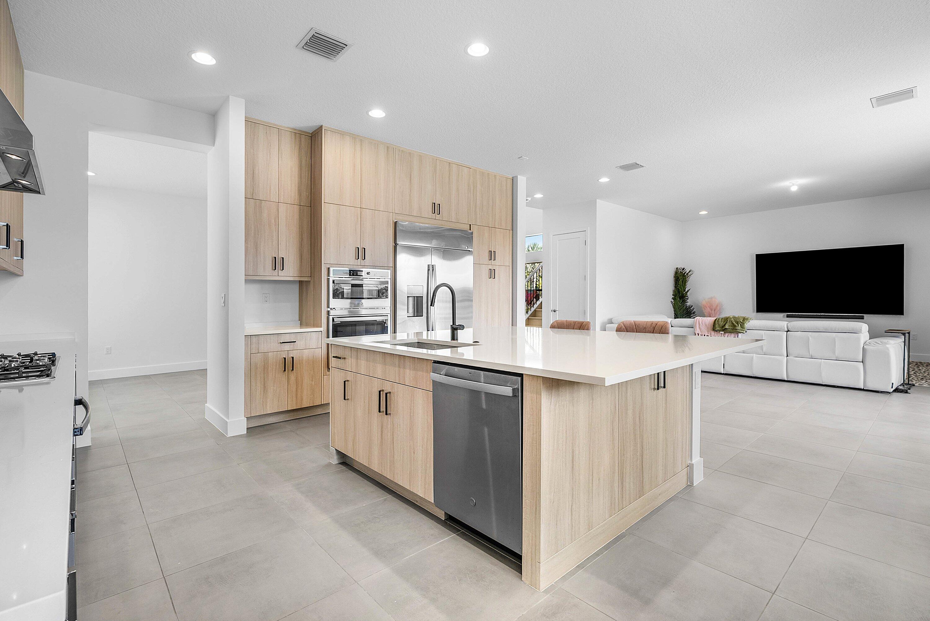 8260 Royal County Down Road Boca Raton, FL 33434 - Photo 20 of 115 a kitchen with stainless steel appliances kitchen island sink and refrigerator