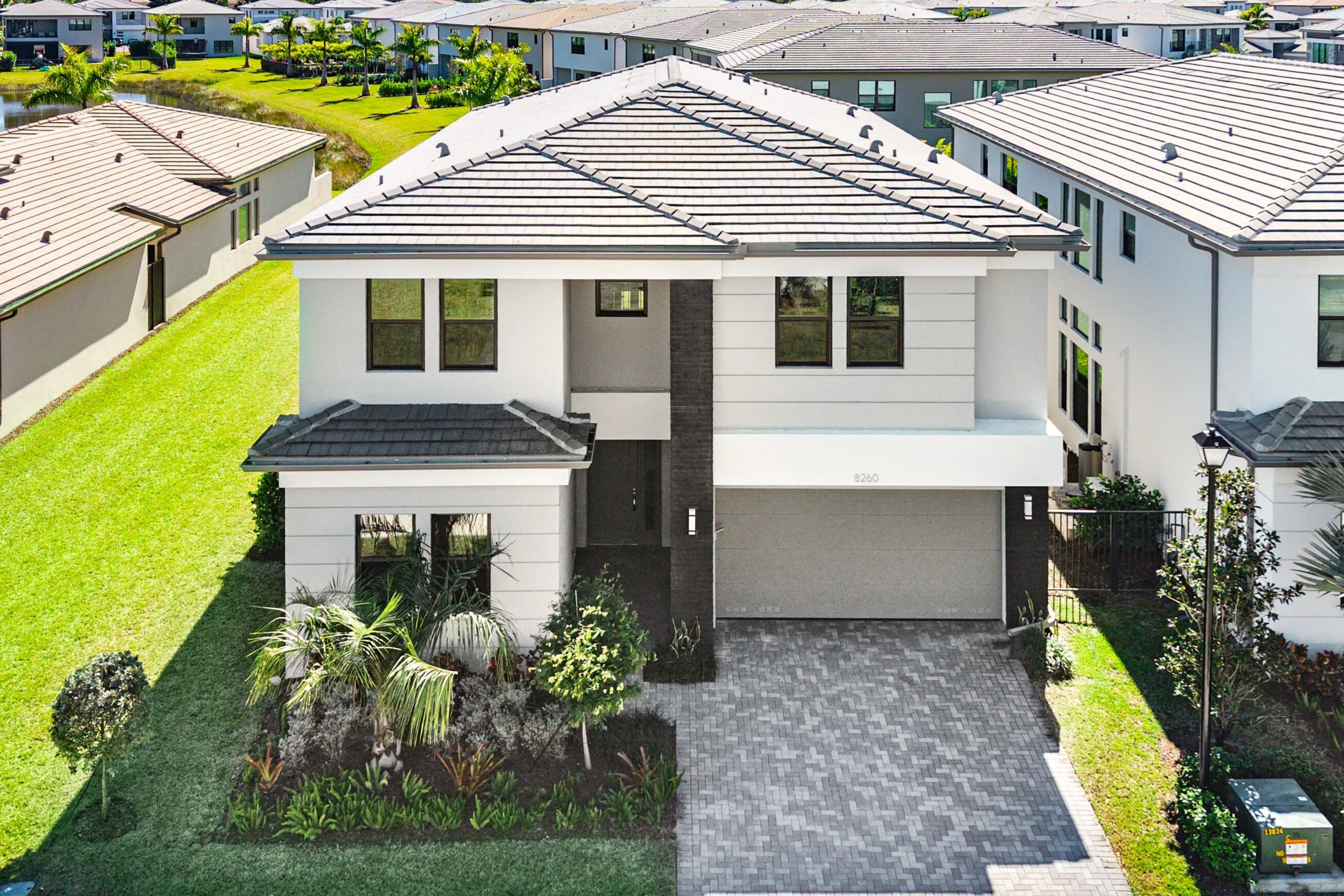 8260 Royal County Down Road Boca Raton, FL 33434 - Photo 2 of 115 a front view of a house with a yard