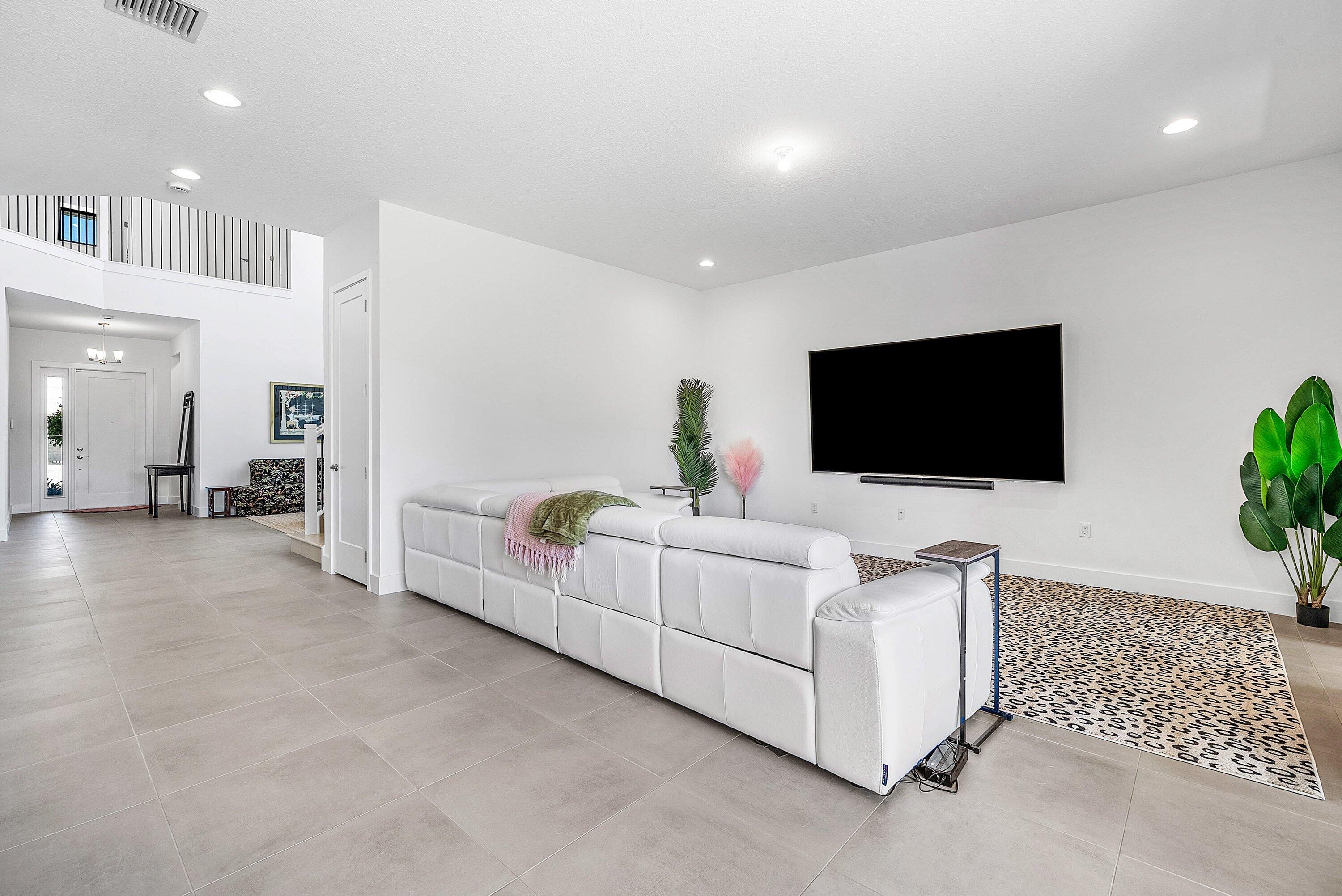 8260 Royal County Down Road Boca Raton, FL 33434 - Photo 23 of 115 a living room with furniture and a flat screen tv