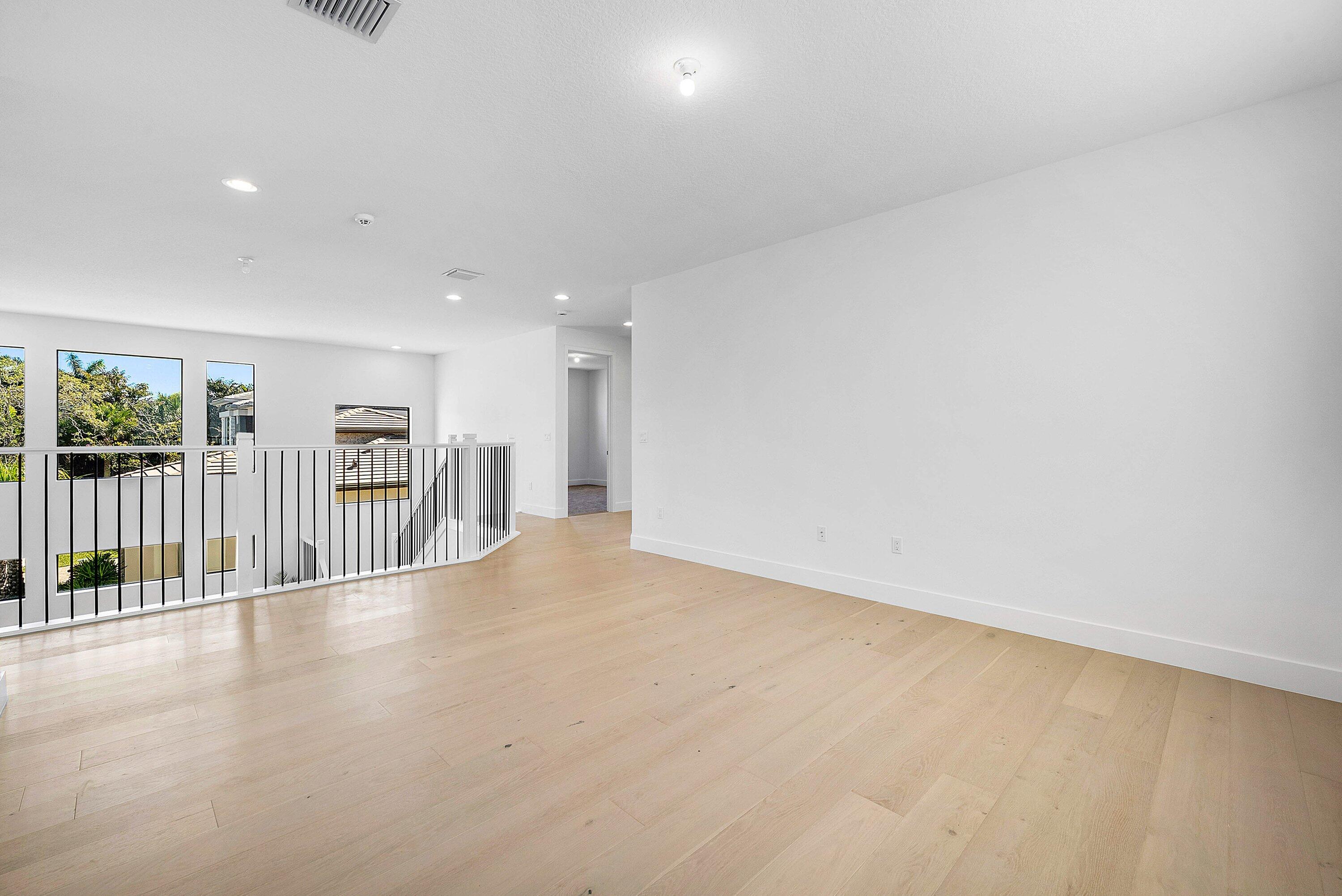8260 Royal County Down Road Boca Raton, FL 33434 - Photo 35 of 115 a view of an empty room with wooden floor