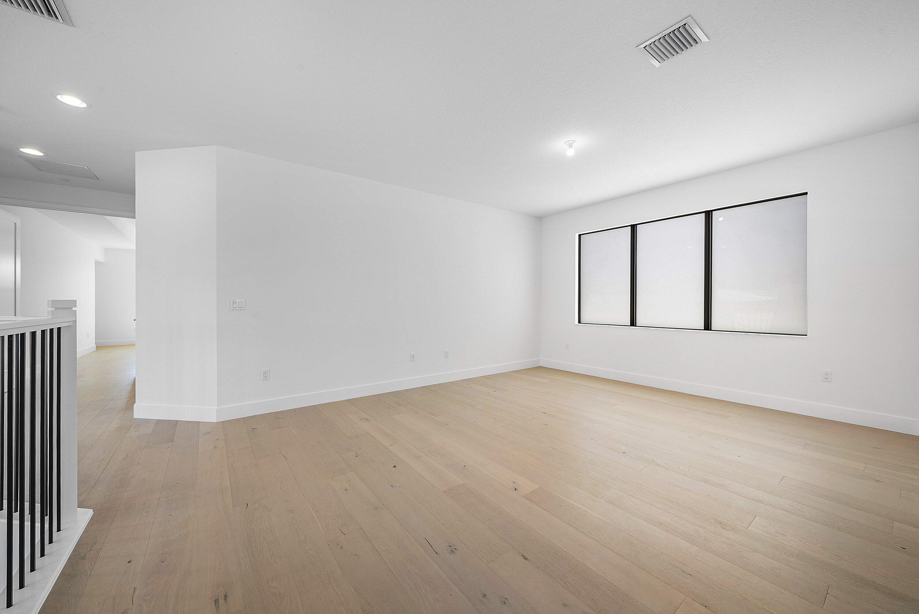 8260 Royal County Down Road Boca Raton, FL 33434 - Photo 38 of 115 a view of an empty room with wooden floor and a window