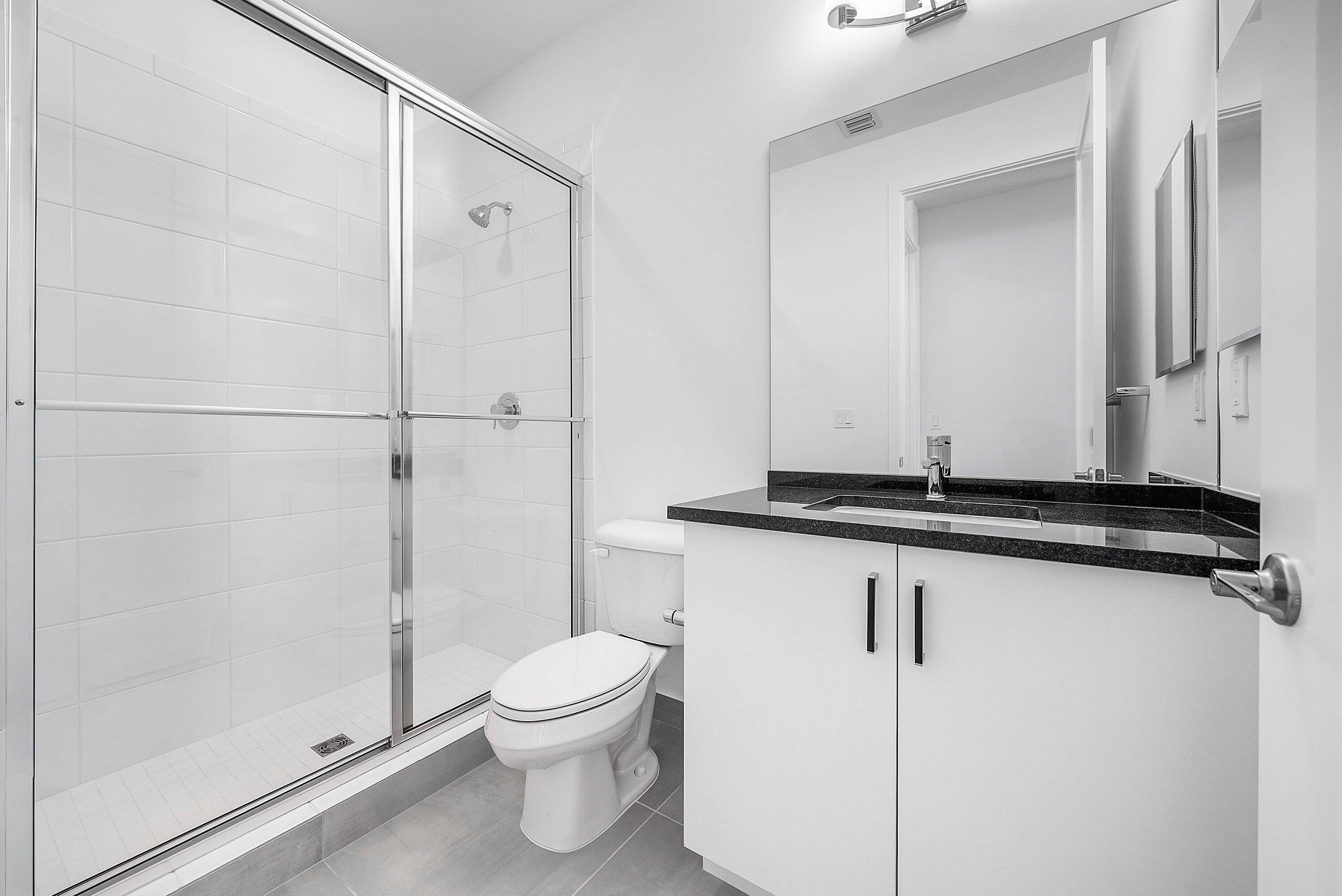 8260 Royal County Down Road Boca Raton, FL 33434 - Photo 40 of 115 a bathroom with a shower a toilet and a sink