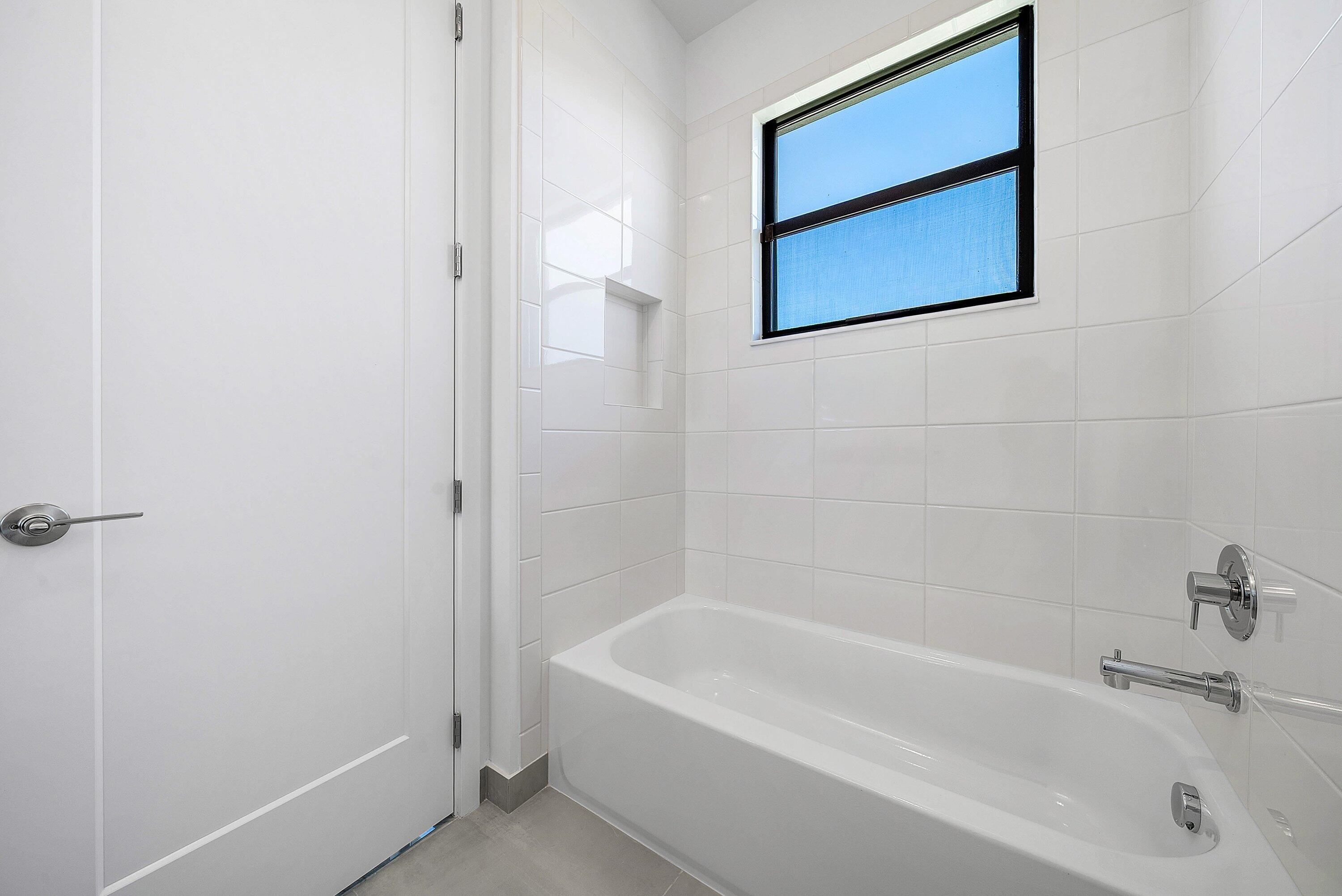 8260 Royal County Down Road Boca Raton, FL 33434 - Photo 43 of 115 a white bath tub sitting next to a white sink and vanity