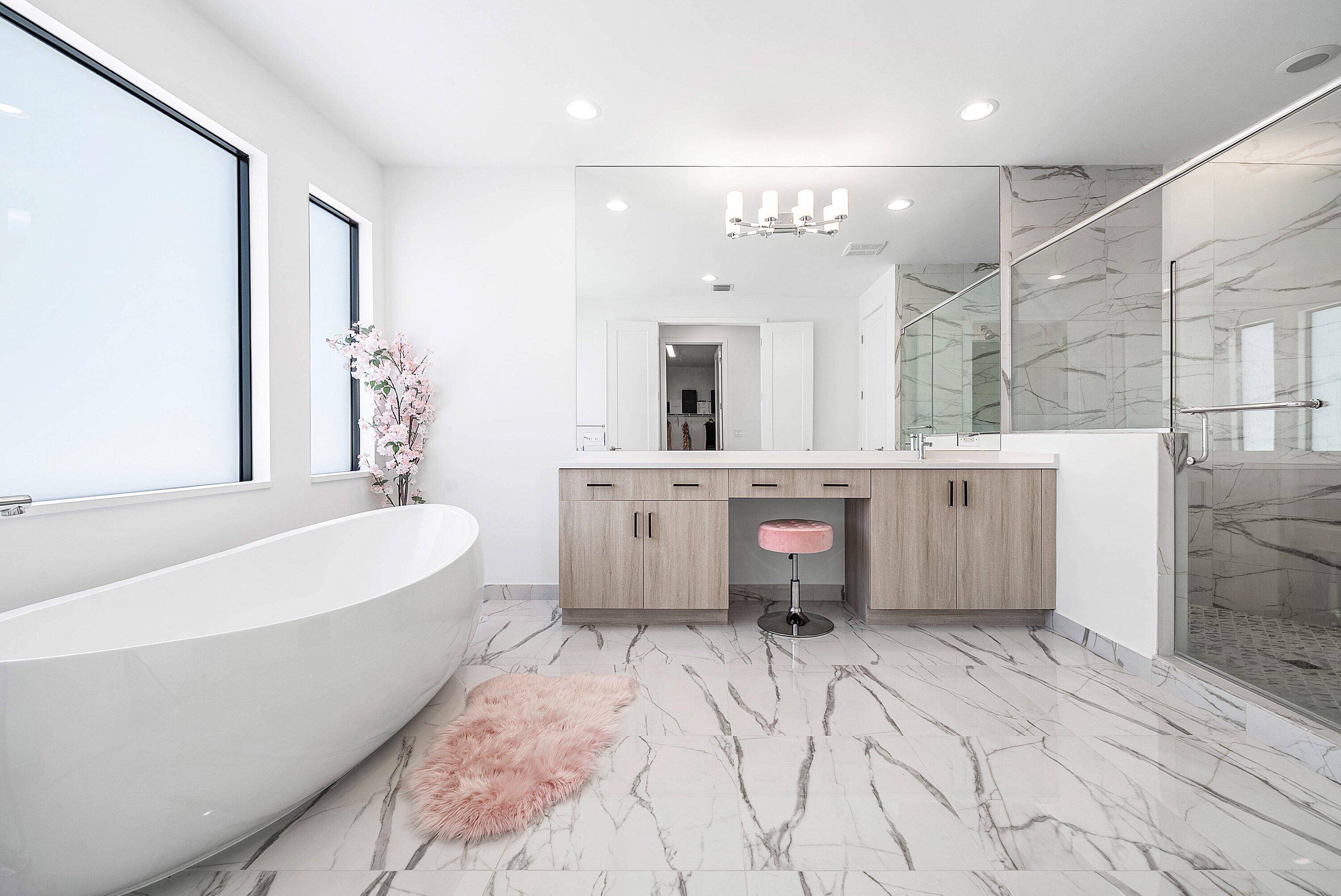 8260 Royal County Down Road Boca Raton, FL 33434 - Photo 48 of 115 a spacious bathroom with a tub sink a mirror and a shower