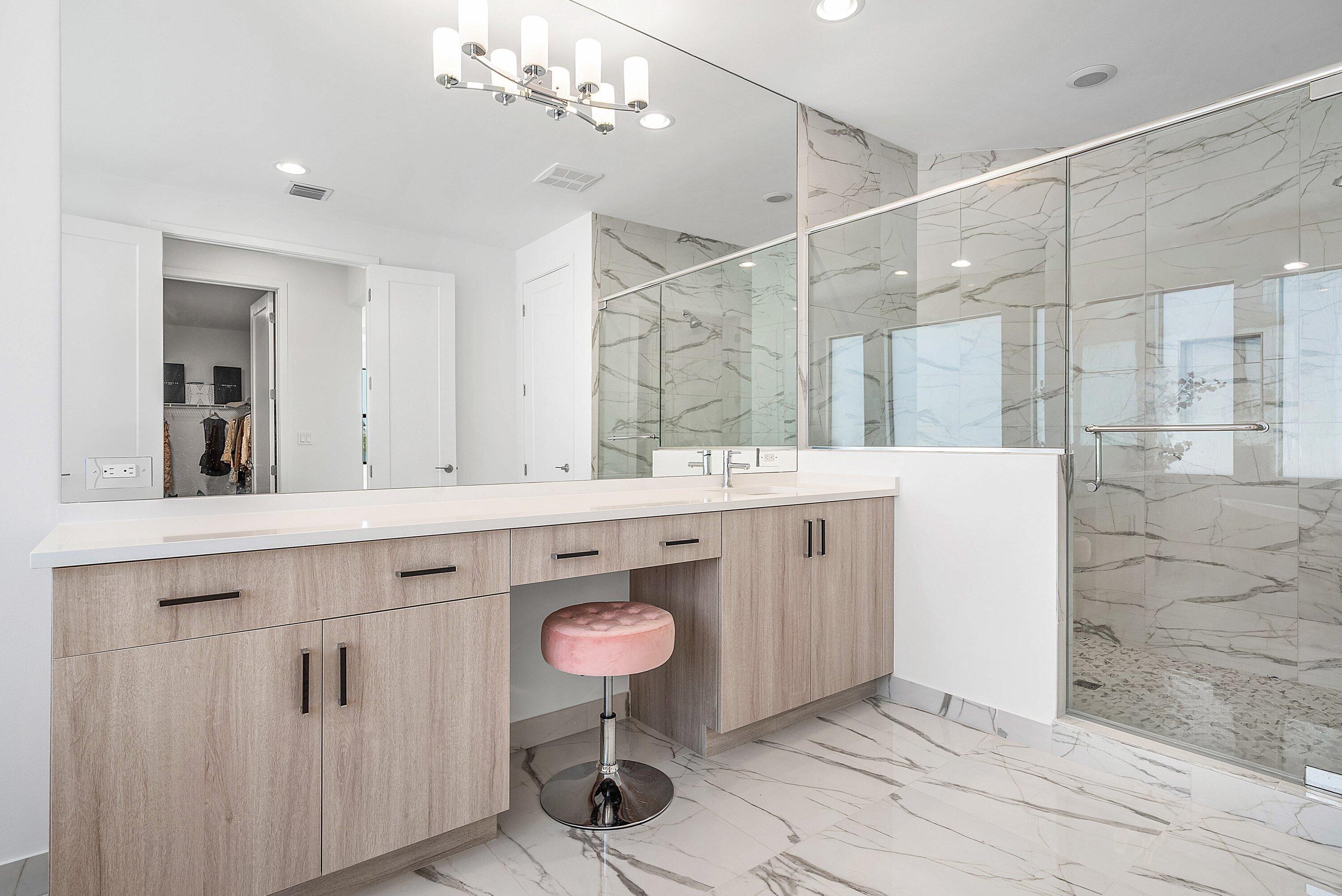 8260 Royal County Down Road Boca Raton, FL 33434 - Photo 49 of 115 a spacious bathroom with a double vanity sink a mirror and a shower