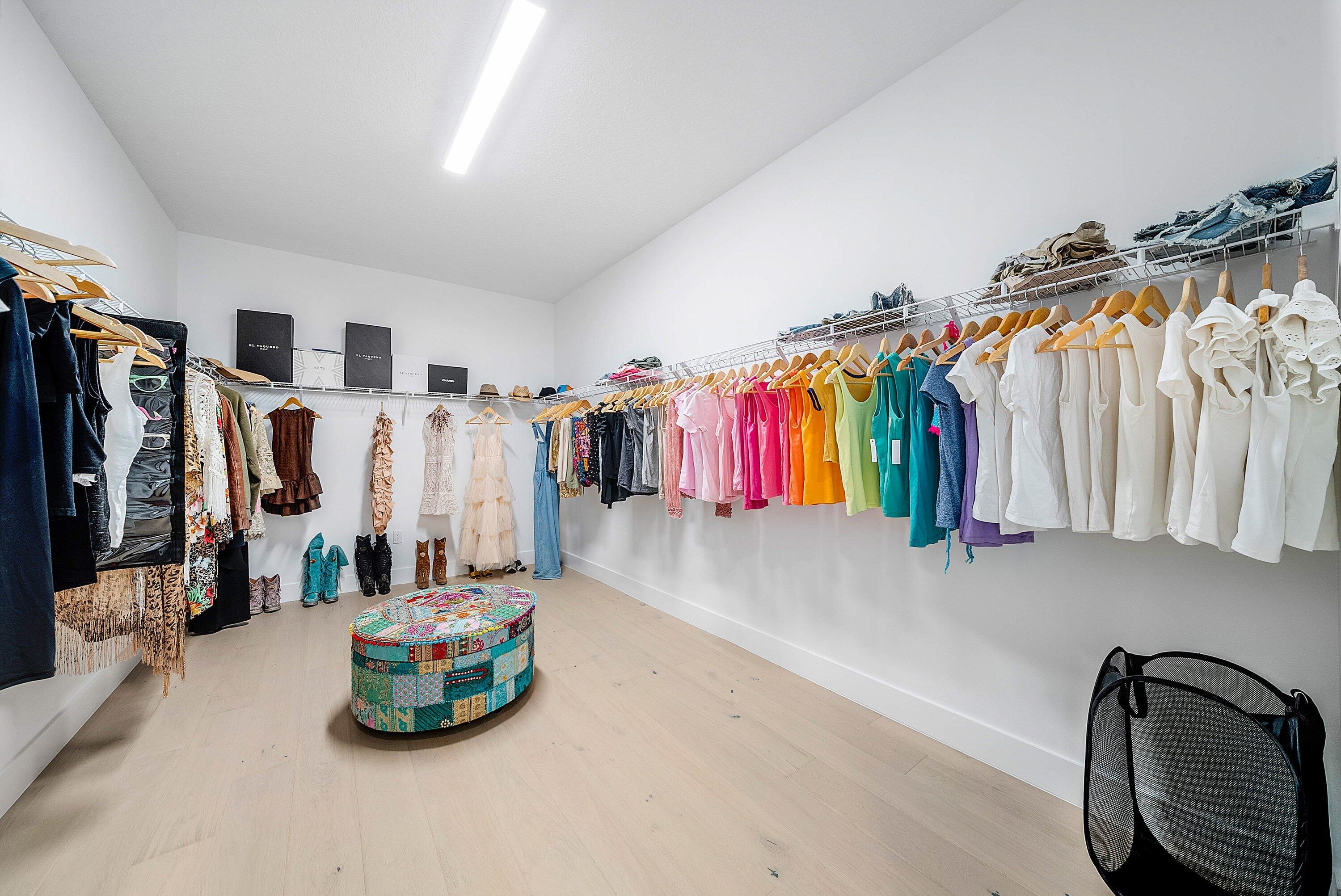 8260 Royal County Down Road Boca Raton, FL 33434 - Photo 51 of 115 a view of walk in closet with clothes and shoes