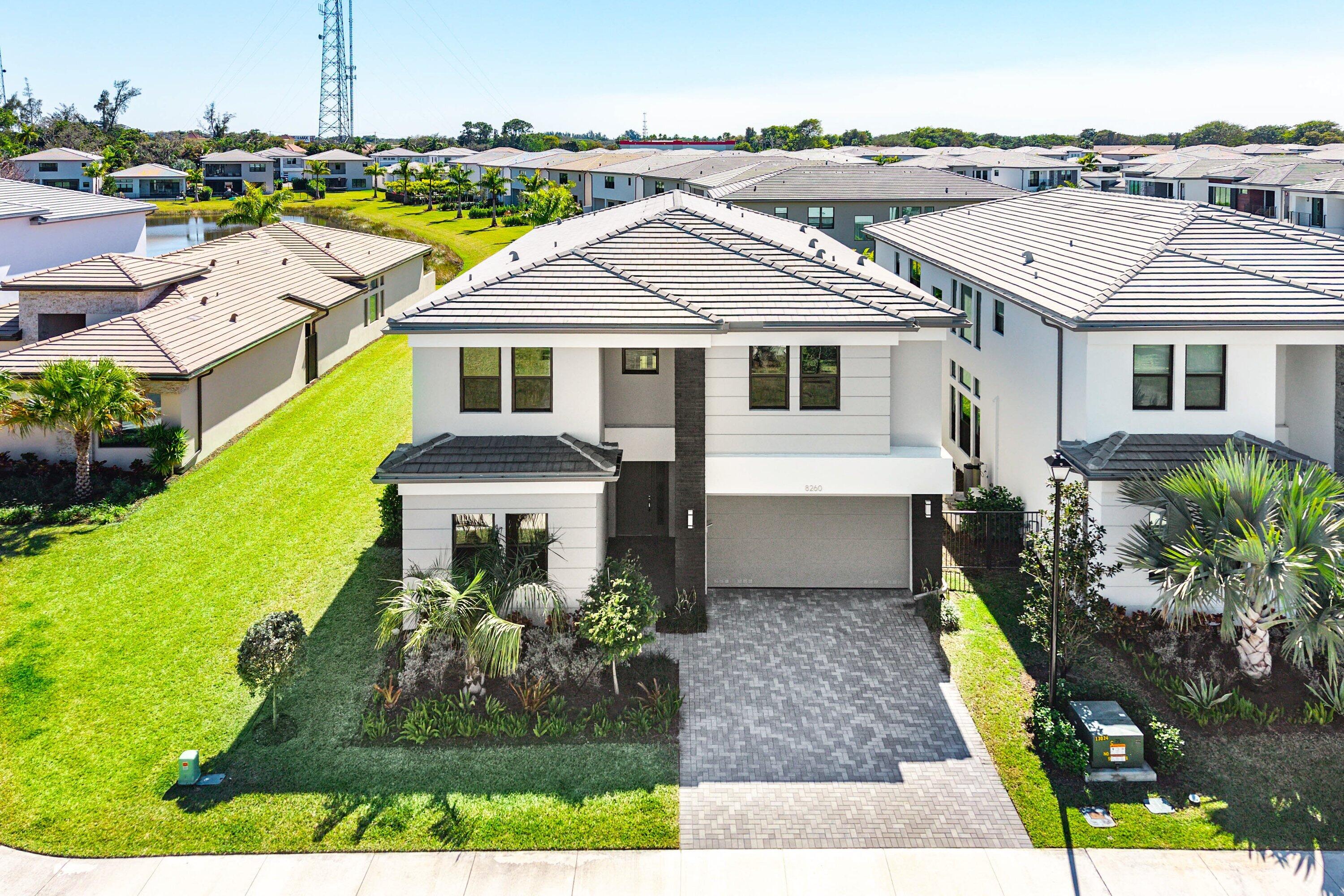 8260 Royal County Down Road Boca Raton, FL 33434 - Photo 63 of 115 a aerial view of a house with a big yard and potted plants