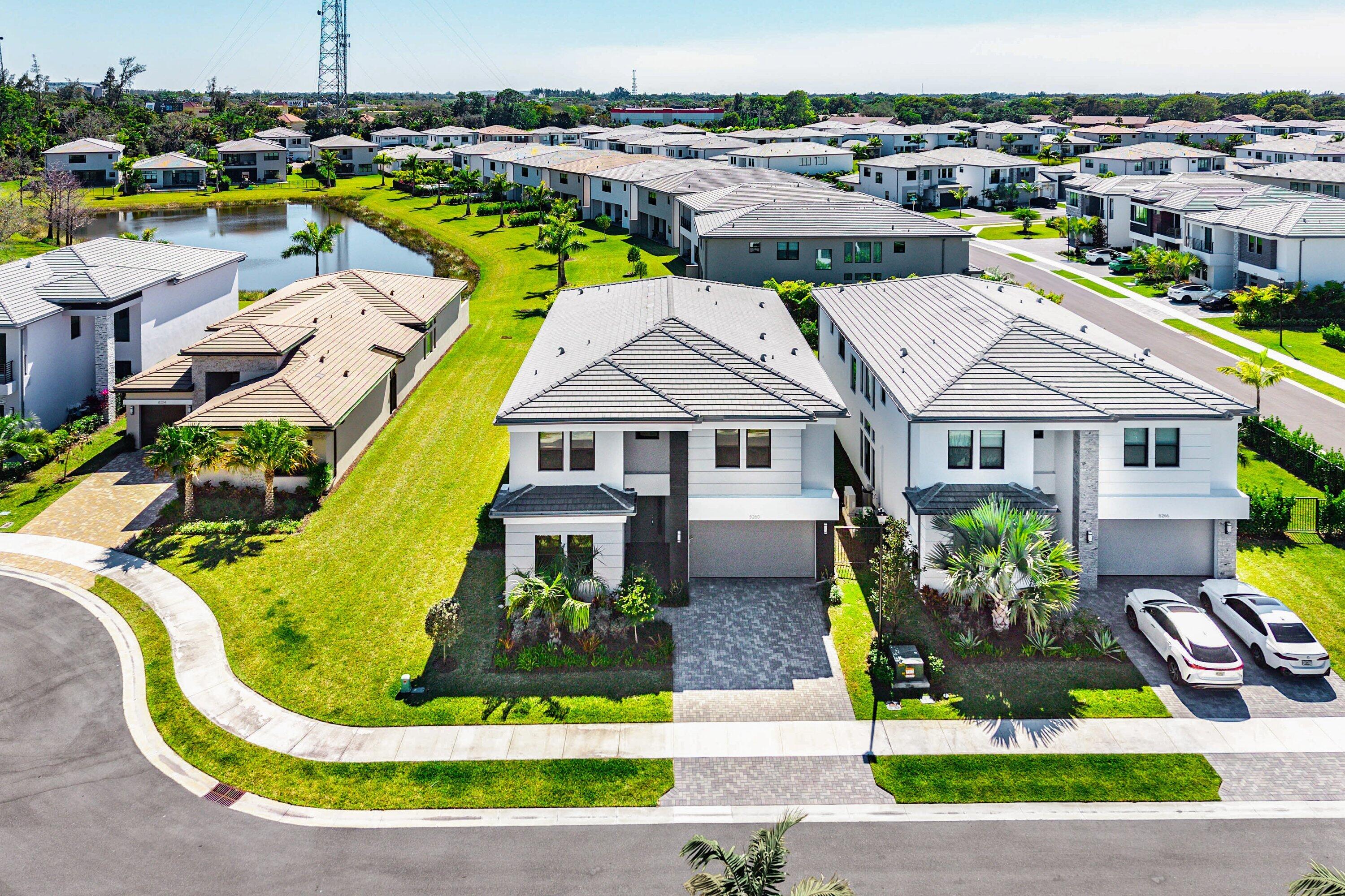 8260 Royal County Down Road Boca Raton, FL 33434 - Photo 64 of 115 a aerial view of a house with swimming pool lawn chairs and lake view
